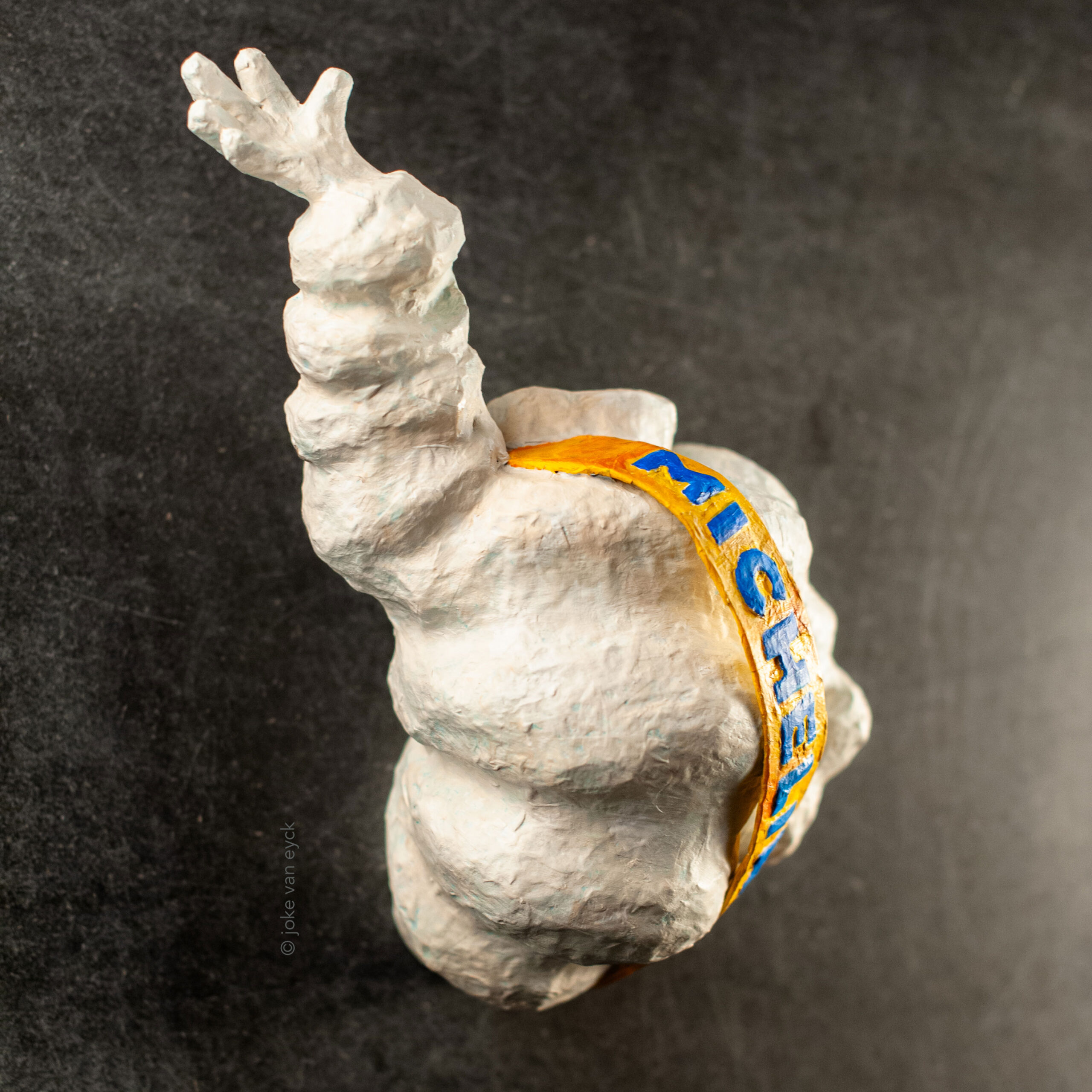 Torso of Michelin - Bibendum. Recycled paper pulp, painted.