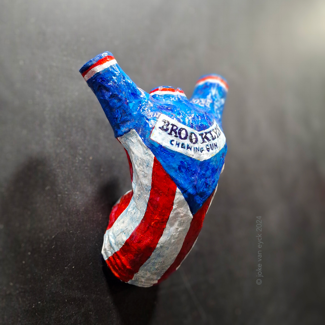 Painted Sculpture. Torso of Roger de Vlaeminck in a Brooklyn shirt. Hands up. Recycled paper pulp, painted. Artwork by ©joke van eyck